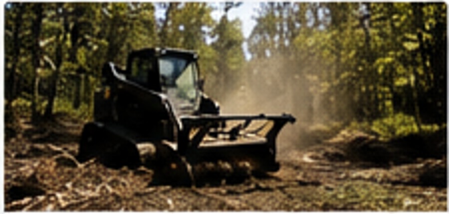 Brush clearing equipment working through wooded property